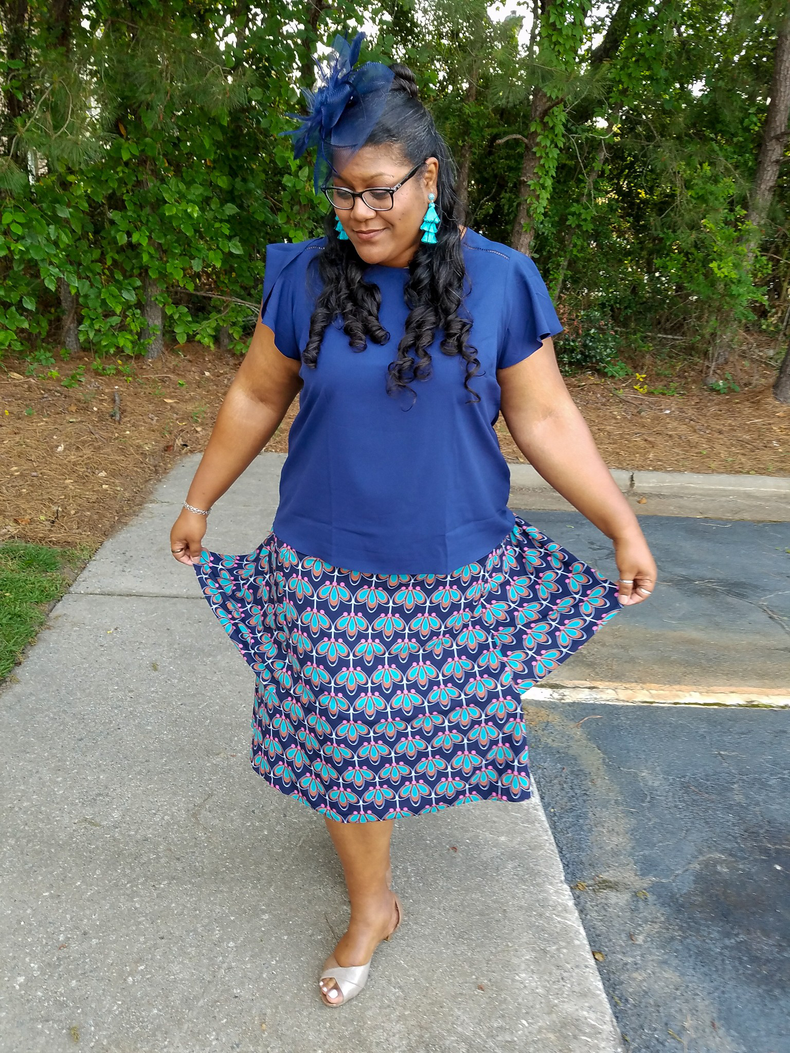 Blue print skirt and fascinator hat.