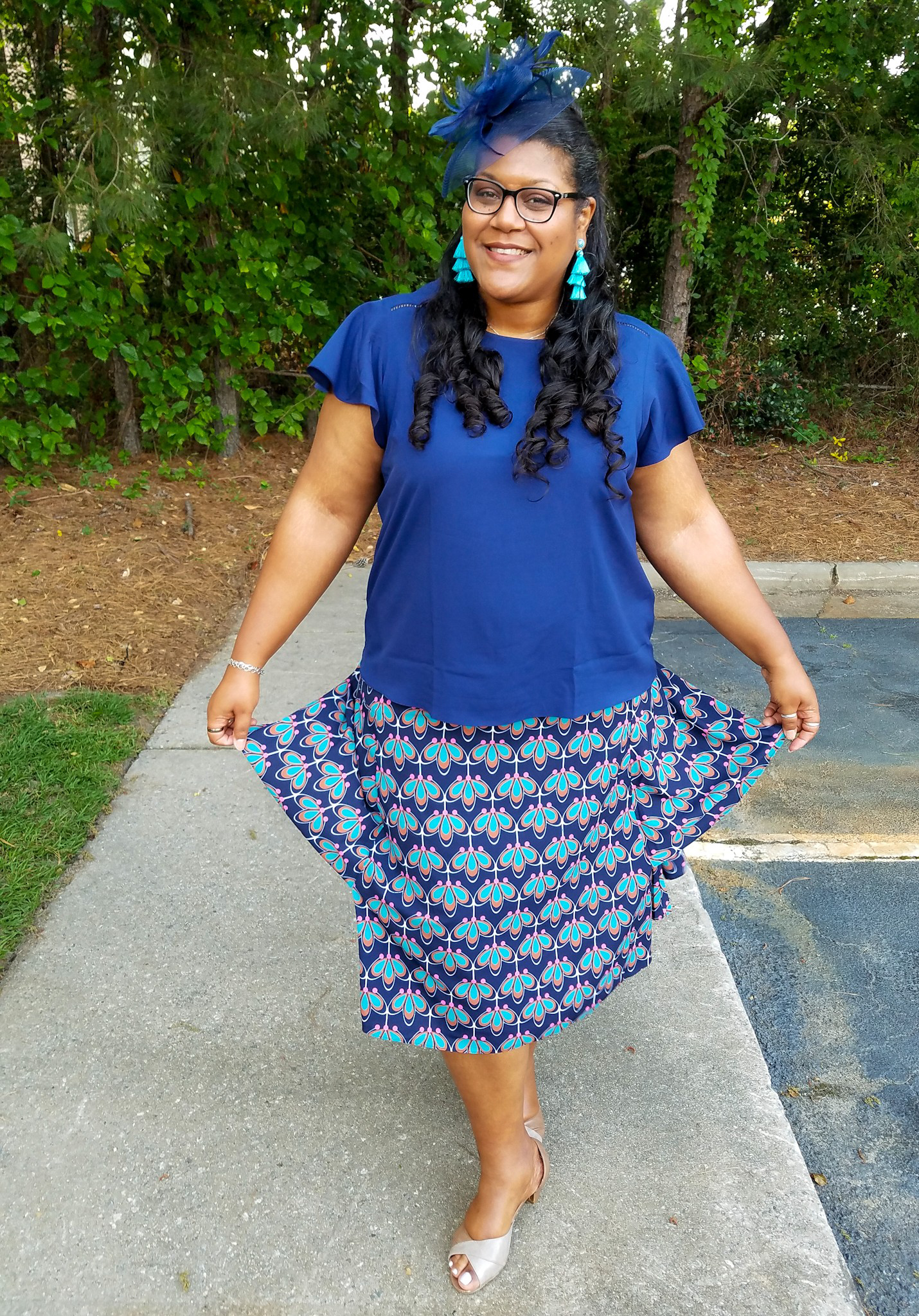 Blue print skirt and fascinator hat.